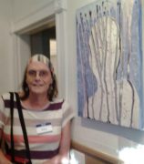 A photo of Amy at the Chelsea Artwalk in 2015 in front of her painting Infusion 2015